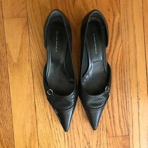black leather pointed-toe pumps with kitten heel